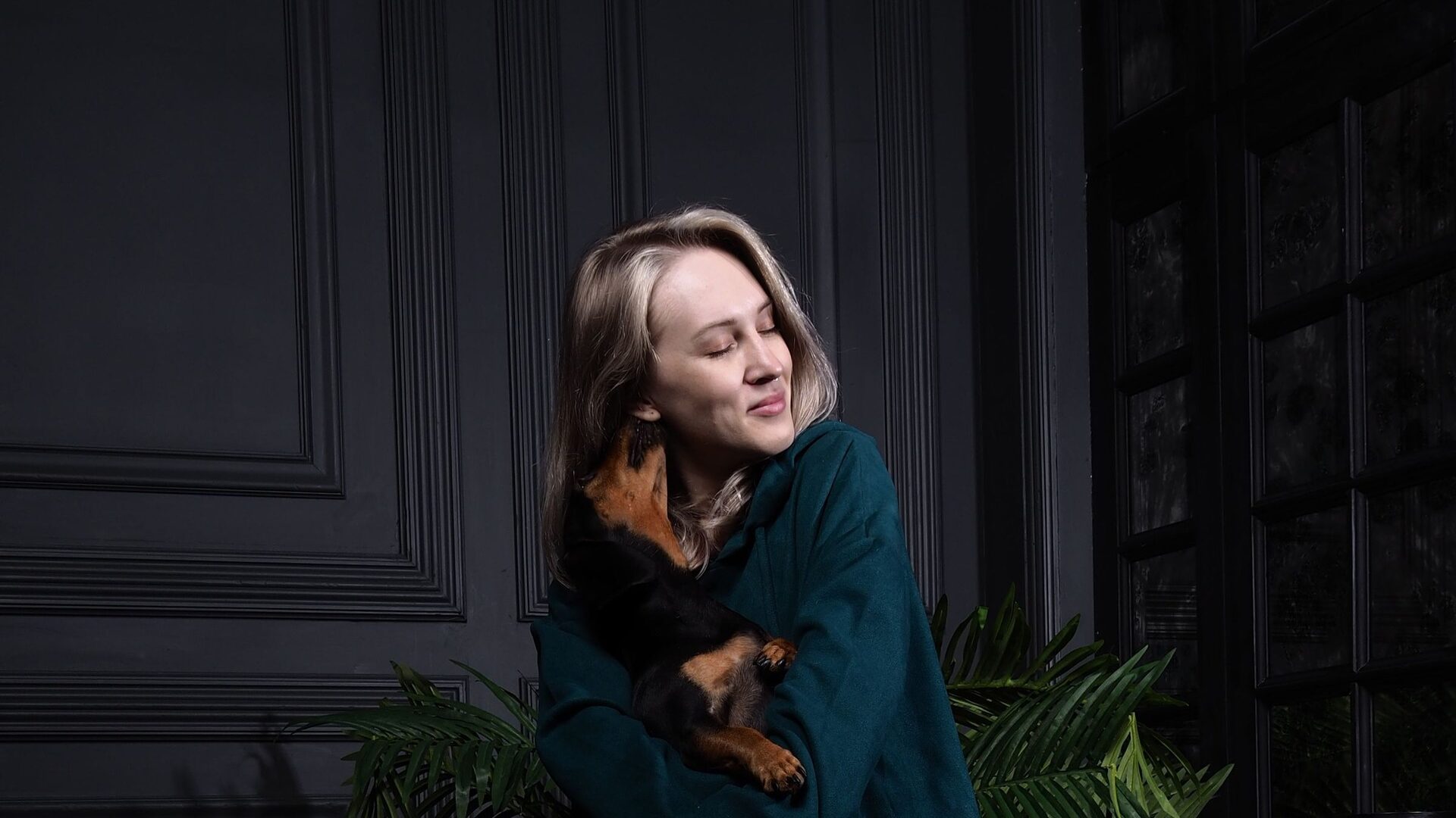 A pet owner tenderly holding her puppy